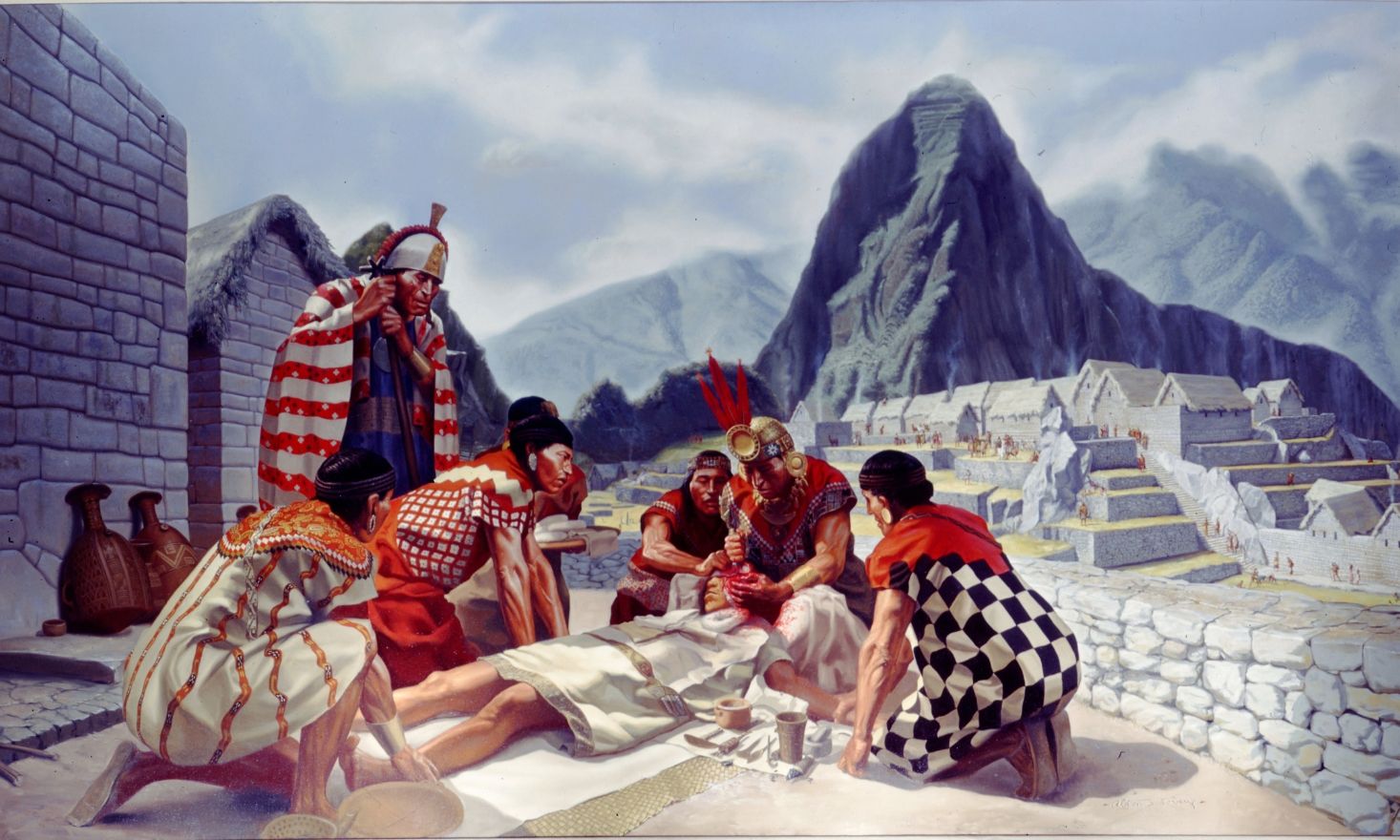 Incas operating on a reclined individual with mountains in the background.