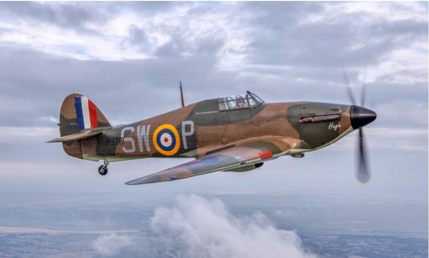 photo of hurricane plane flying over clouds